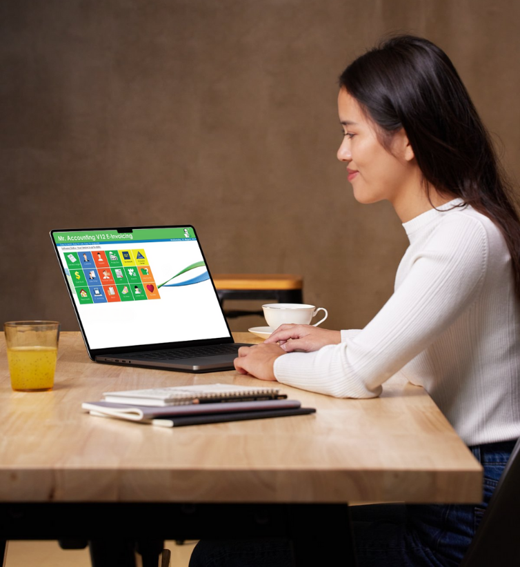 Malaysian Professional using Plenitude IT's E-Invoicing Software on Laptop